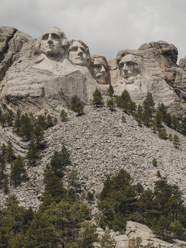 a group of mountains with trees on each side