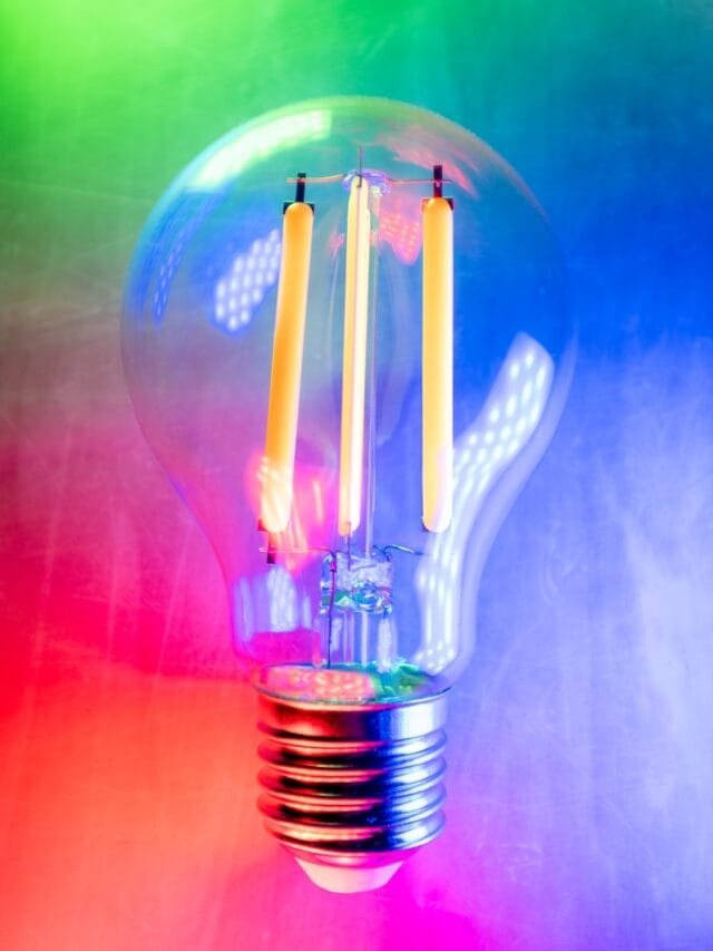 a light bulb with two candles inside of it